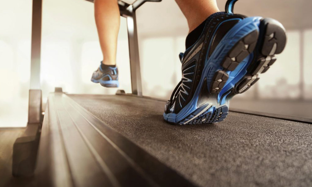 Close-up of a patient’s running shoes on a treadmill